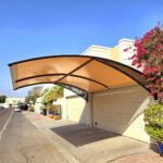 Cantilevered beige carport structure installed by a leading car parking shade supplier in Dubai, designed by Pergola Shed