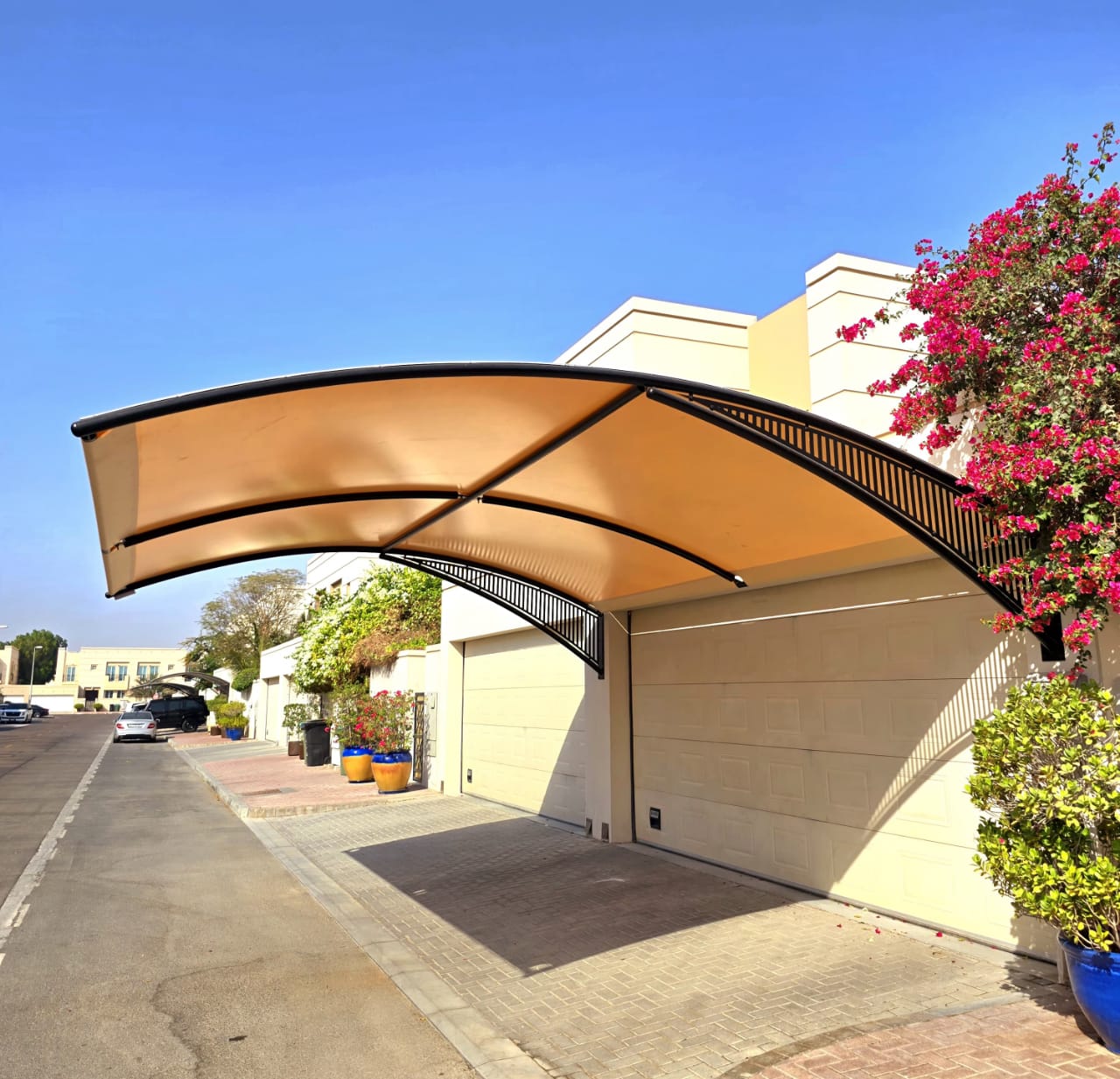 Cantilevered beige carport structure installed by a leading car parking shade supplier in Dubai, designed by Pergola Shed