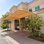 Modern arched fabric canopy design used for a two car parking shade in Abu Dhabi residential villas.