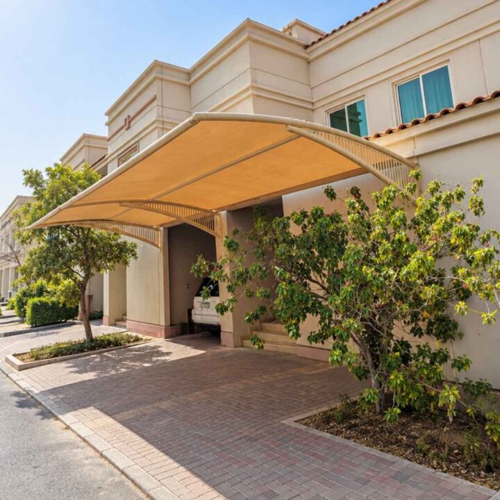 Modern arched fabric canopy design used for a two car parking shade in Abu Dhabi residential villas.