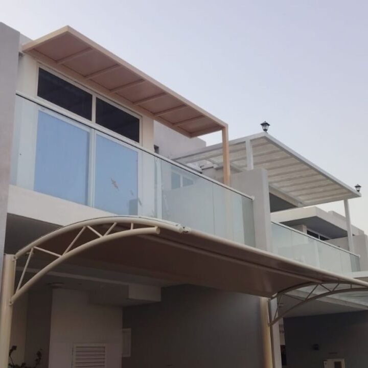Modern curved arched car parking shade installed outside a villa in Damac Hills 2